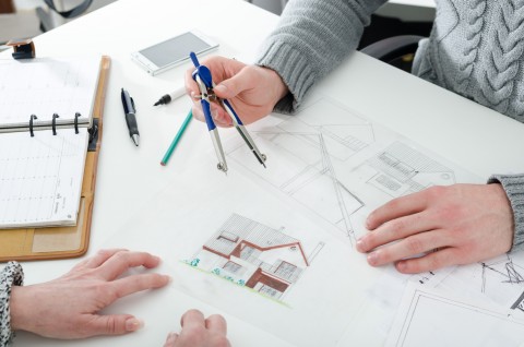 Architect showing house plans to his client